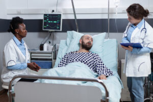Dying patient with nurse on sick bed