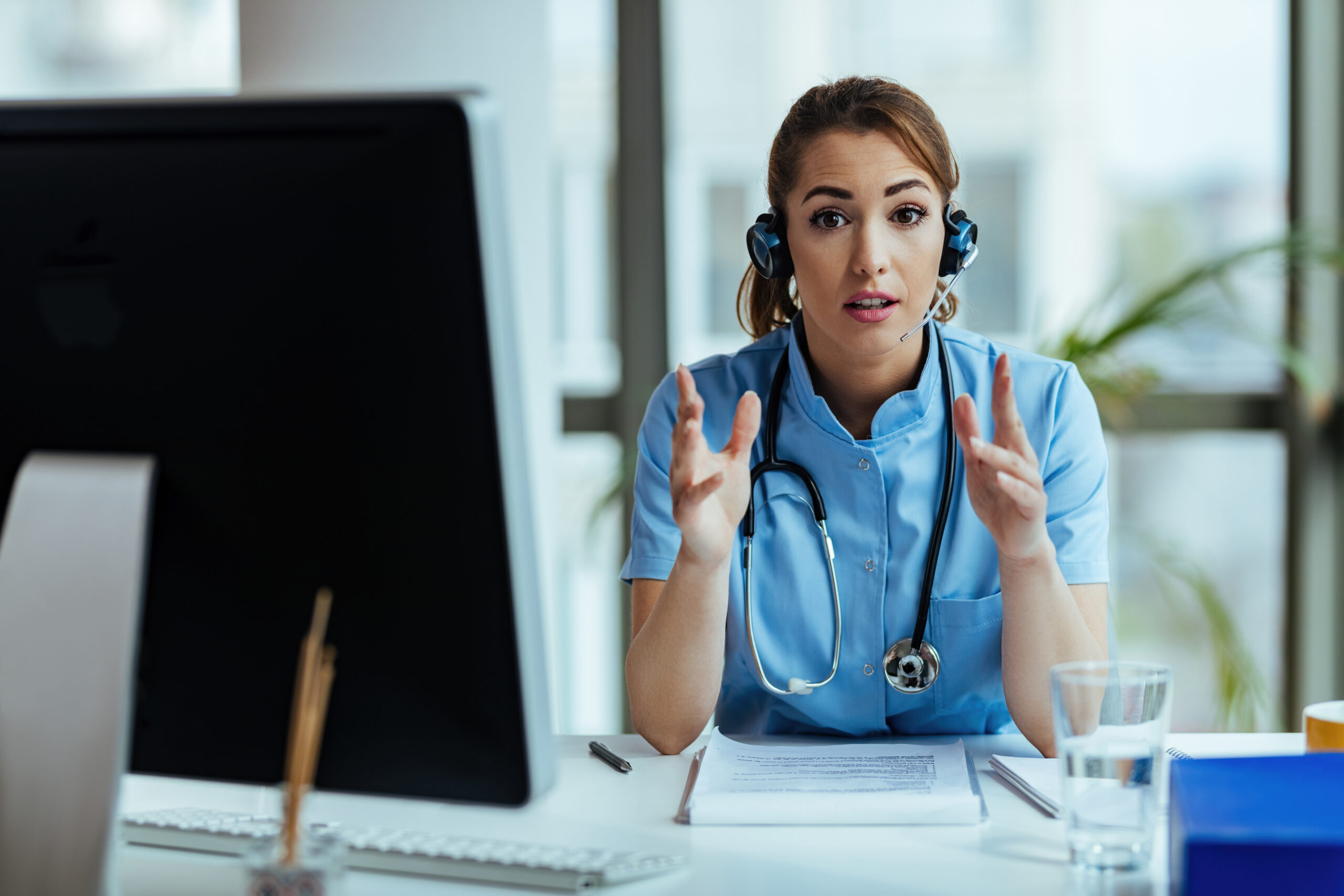 Nurse providing remote healthcare staffing consultation via video call
