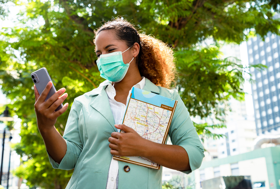 Nurse staring at her device on a travel nursing job assignment