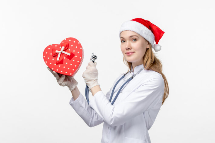 healthcare staffing - White female nurse holding love shape