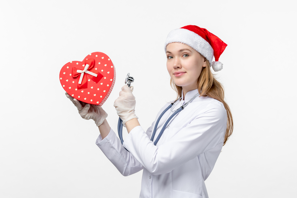 healthcare staffing - White female nurse holding love shape