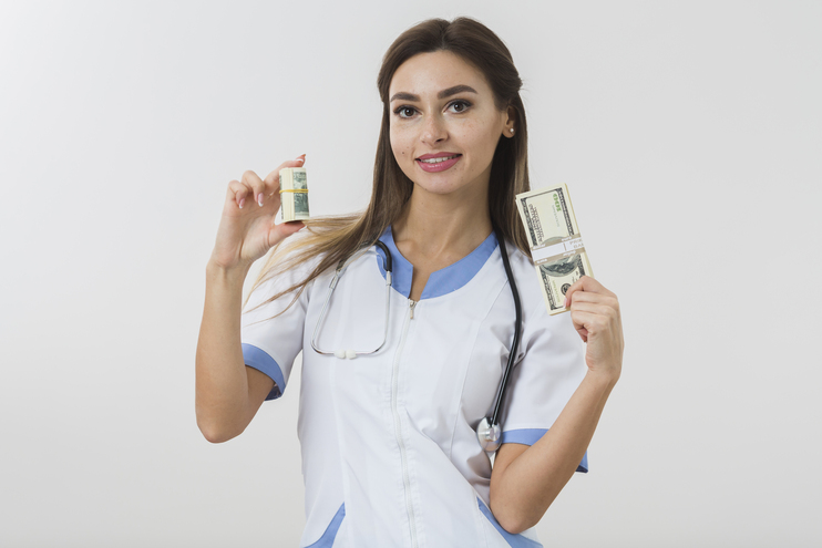 Nurses earn in canada - white nurse displaying cash