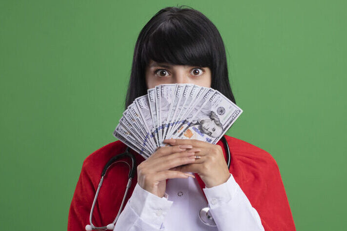 Nurses earn in Canada - white female nurse displaying cash